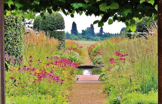 Walled garden with prairie plantings and water rill at Broughton Grange Garden