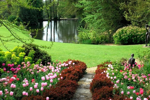 Pretty pink tulips leading you down to the lake at Pashley Manor Gardens